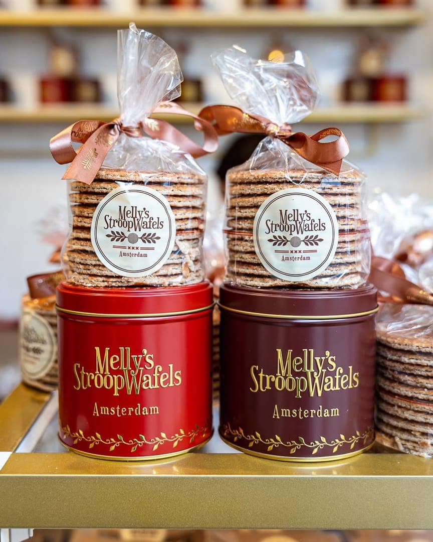 Melly's Stroopwafels red and chocolate gift tins with wrapped stroopwafel stacks