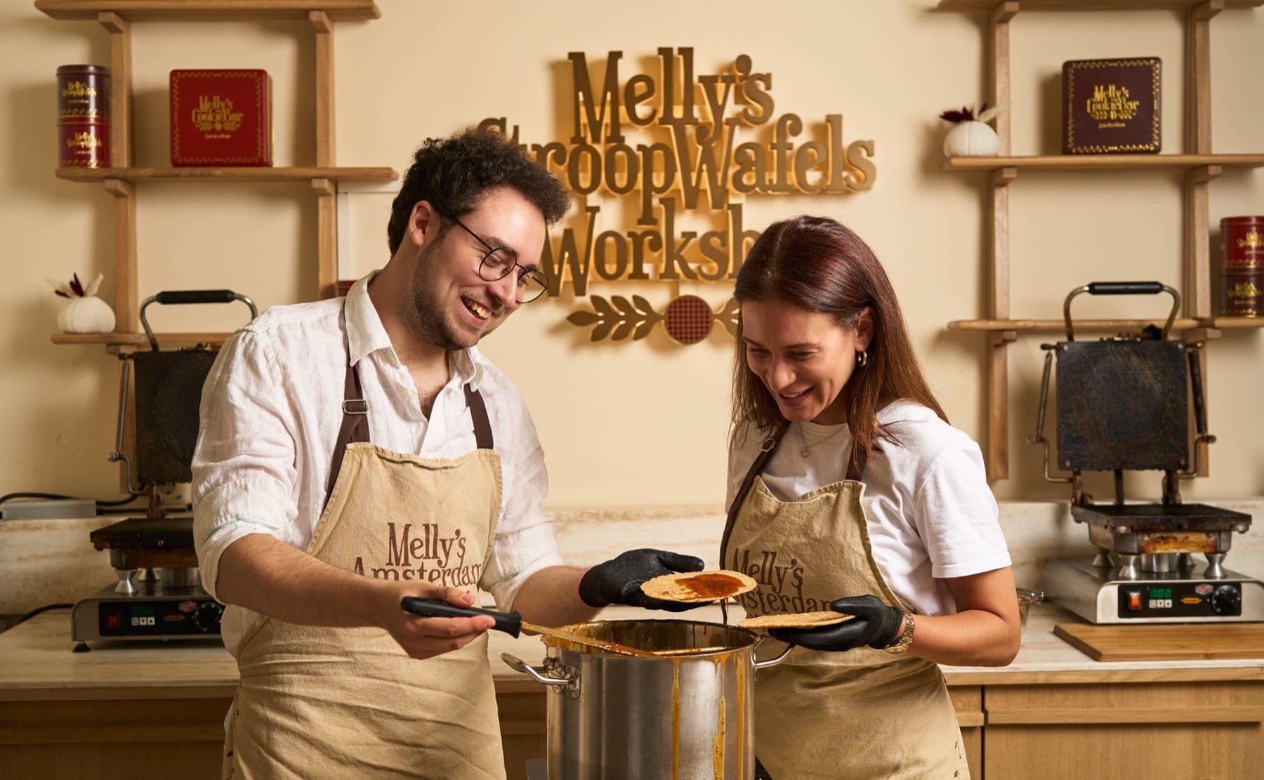Pressing a fresh stroopwafel on the iron at Melly's workshop
